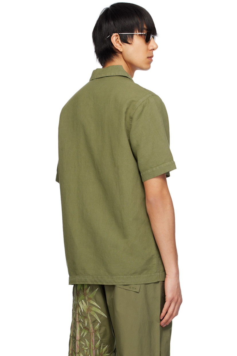Lightweight hemp- and cotton-blend canvas shirt. Subtle distressing throughout.

· Open spread collar
· Button closure
· Patch pocket
· Hand-machined graphic embroidered at front
· Logo flag at side seam

Supplier color: Olive