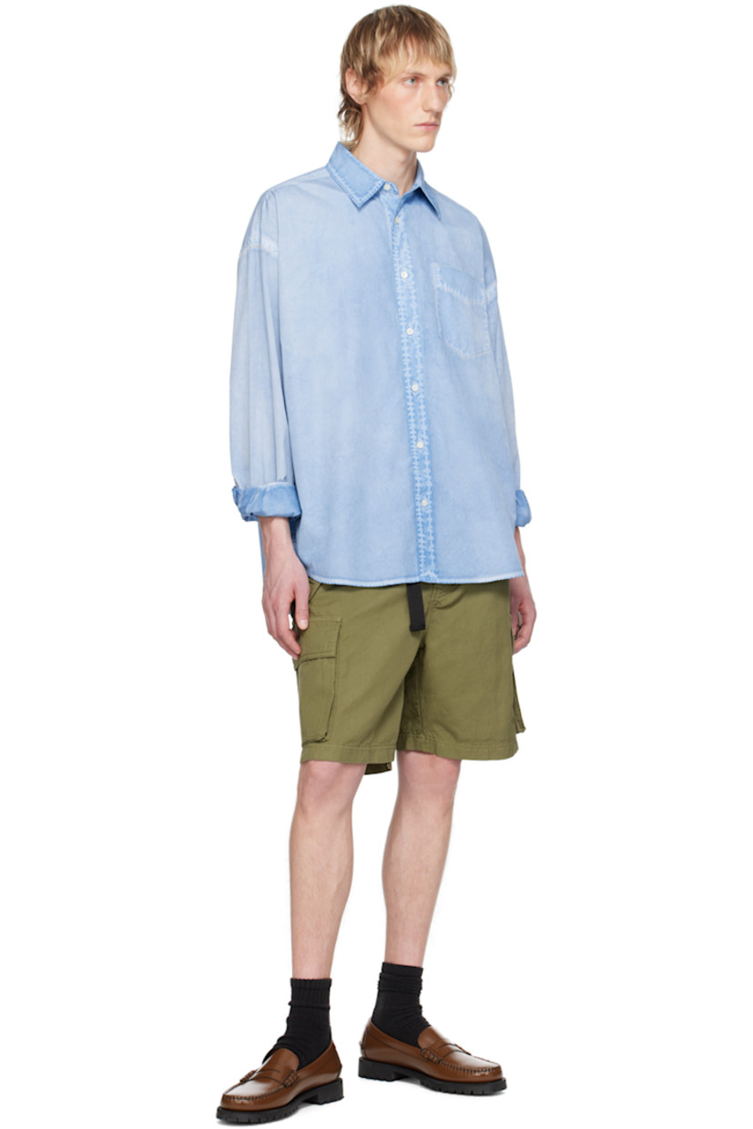 Garment-dyed cotton poplin shirt. Fading throughout.

· Spread collar
· Button closure
· Patch pocket 
· Shirttail hem
· Dropped shoulders
· Adjustable single-button barrel cuffs
· Box pleat at back yoke
· Mother-of-pearl hardware

Supplier color: Aqua blue