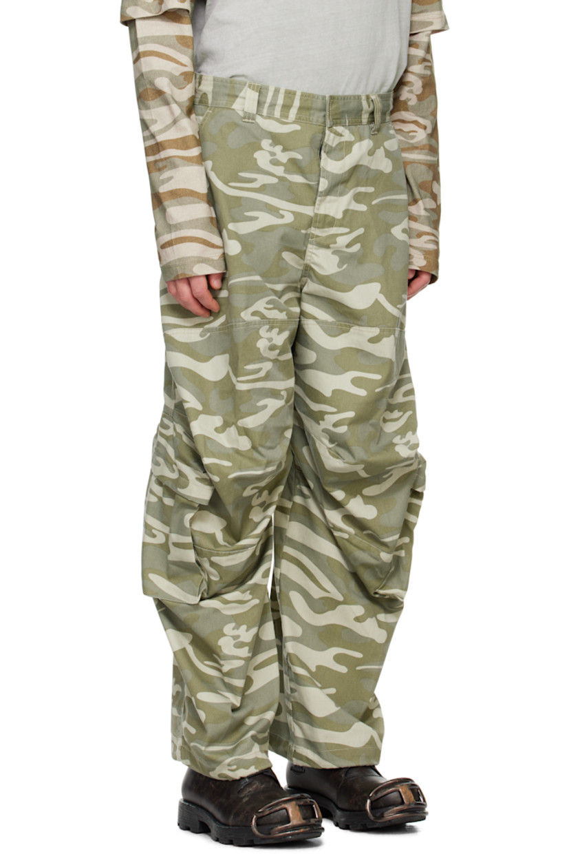 Polyester- and cotton-blend twill cargo pants. Camouflage pattern printed throughout. 

· Paneled construction
· Belt loops
· Concealed drawstring at waistband
· Four-pocket styling
· Zip-fly
· Darts and draping at knees
· Concealed bungee-style drawstring at cuffs
· Cargo pocket at outseams 
· Embroidered logo patch at back waistband

Supplier color: Green