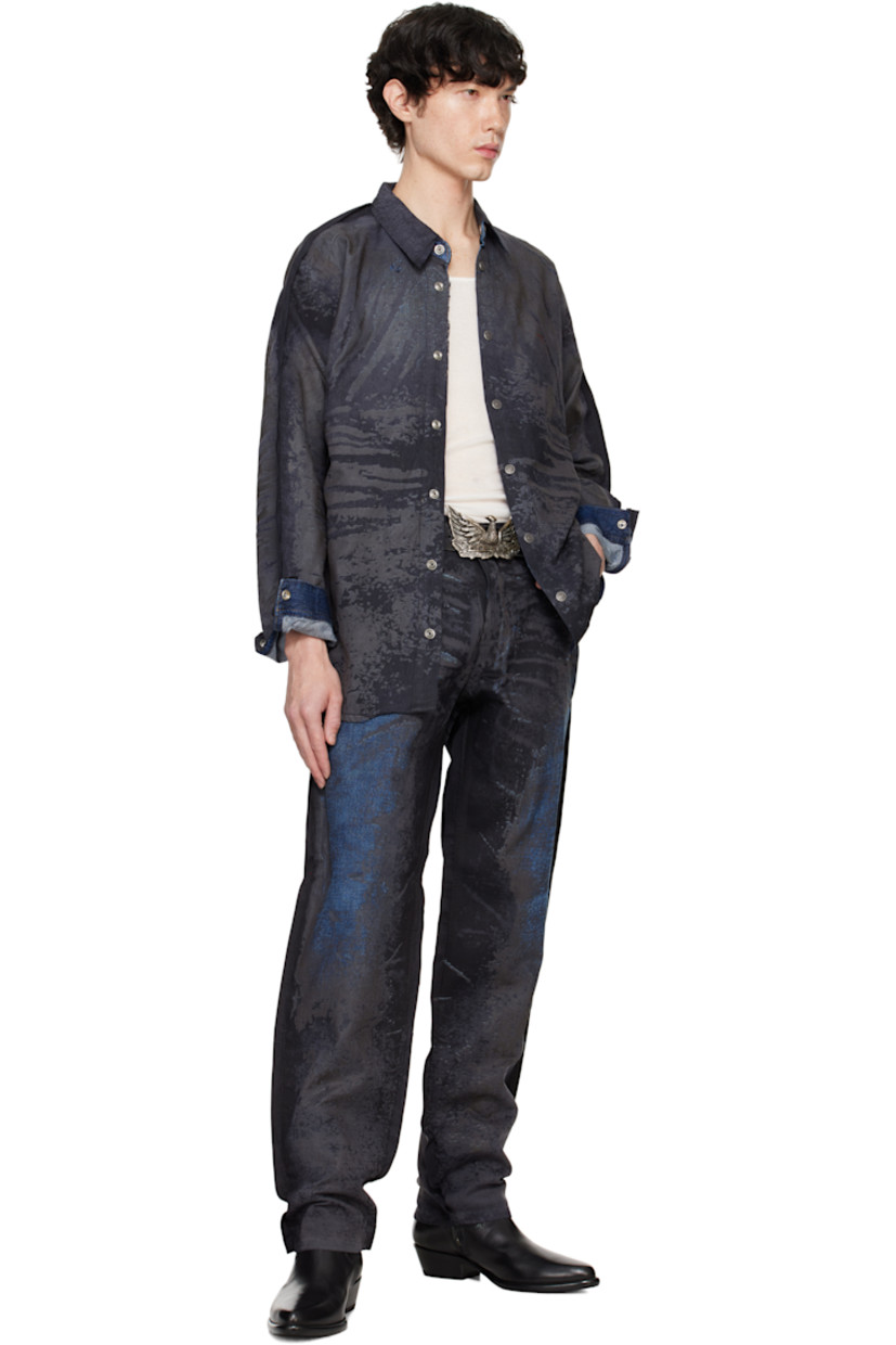 Coated non-stretch lyocell denim shirt. Fading and whiskering throughout. 

· Spread collar
· Press-stud closure
· Logo embroidered at chest
· Shirttail hem 
· Raw edge at side seams and sleeves
· Single-press-stud barrel cuffs
· Logo-engraved silver-tone hardware

Supplier color: Denim