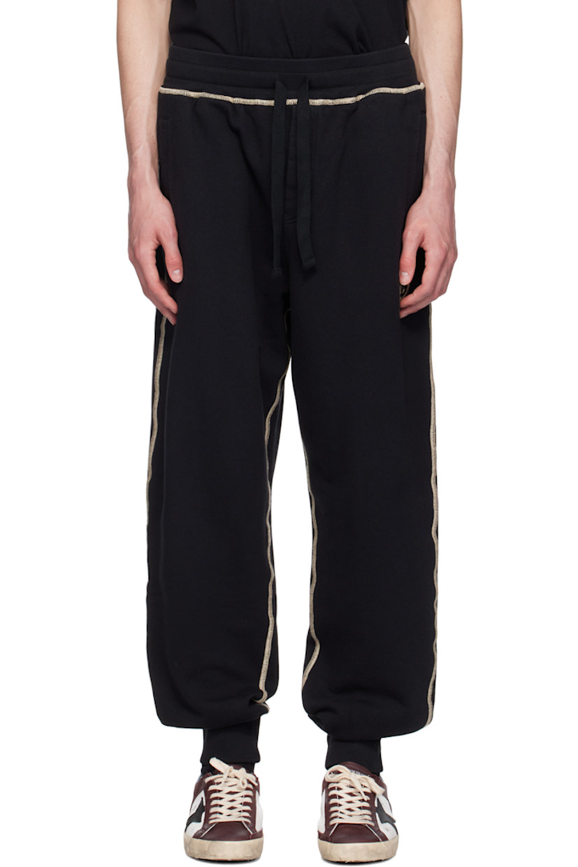 French terry sweatpants. 

· Drawstring at rib knit elasticized waistband 
· Three-pocket styling 
· Mock-fly 
· Logo graphic printed at front and back
· Elasticized cuffs 
· Contrast stitching in beige 

Supplier color: Nero