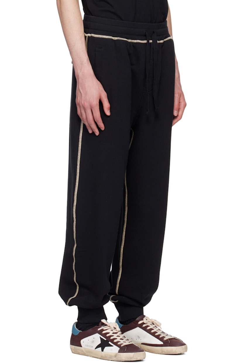 French terry sweatpants. 

· Drawstring at rib knit elasticized waistband 
· Three-pocket styling 
· Mock-fly 
· Logo graphic printed at front and back
· Elasticized cuffs 
· Contrast stitching in beige 

Supplier color: Nero