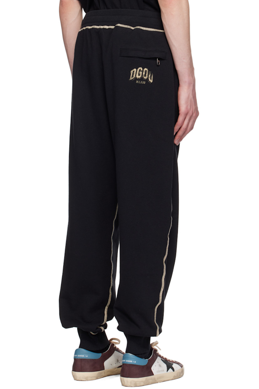 French terry sweatpants. 

· Drawstring at rib knit elasticized waistband 
· Three-pocket styling 
· Mock-fly 
· Logo graphic printed at front and back
· Elasticized cuffs 
· Contrast stitching in beige 

Supplier color: Nero