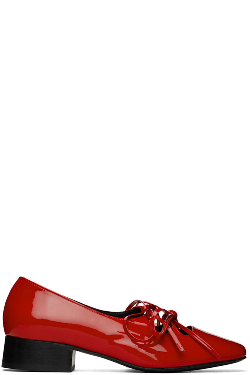 Handcrafted patent leather Mary Jane-style ballerina flats in red.

· Square toe
· Self-tie bow accents at vamp
· Logo embossed at padded footbed
· Buffed leather and suede lining
· Stacked block heel with rubber injection
· Leather sole
· Heel: H1"

Supplier color: Red