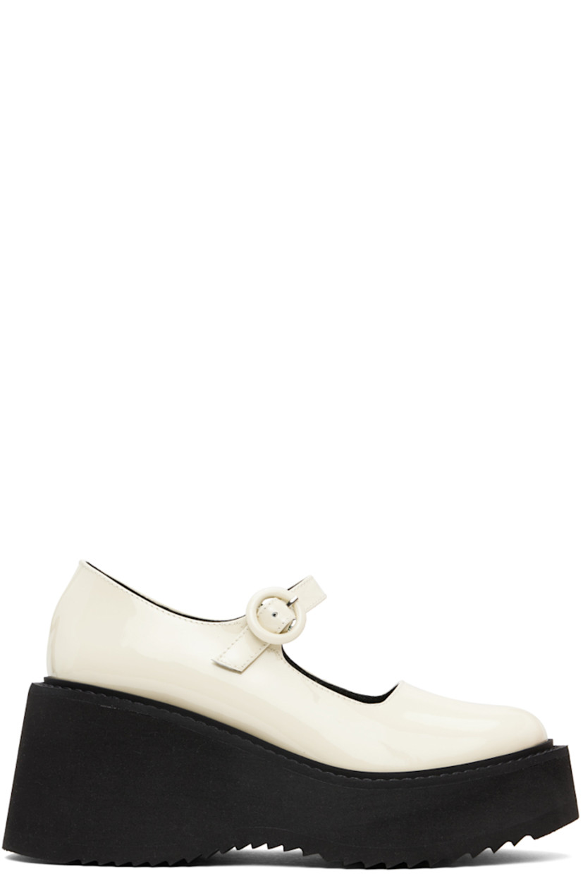 Patent leather Mary Jane-style heels in off-white.

· Pin-buckle strap at vamp
· Logo embossed at padded footbed
· Buffed leather and suede lining
· Foam rubber wedge heel and midsole
· Treaded rubber sole
· Platform: H1.5"
· Heel: H3"

Supplier color: White