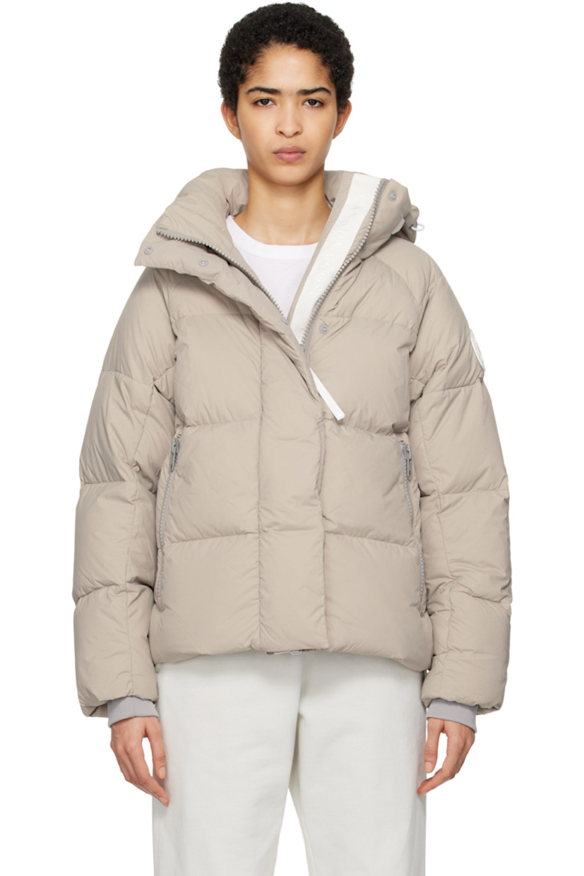 Lightweight down-filled quilted EnduraLuxe CORDURA® nylon taffeta jacket. Water-resistant, wind-resistant, and durable.

· Reflective trim at detachable hood
· Hook strap and bungee-style drawstring at hood
· Funnel neck
· Two-way zip closure with press-stud placket
· Zip pockets
· Concealed bungee-style drawstring at hem
· Raglan sleeves
· Rubberized logo patch at sleeve
· Inset rib knit cuffs
· Patch pockets at interior
· Logo-woven webbing shoulder straps at interior
· Full nylon taffeta lining

Supplier color: Limestone

Fill: 90% goose down, 10% goose feather.