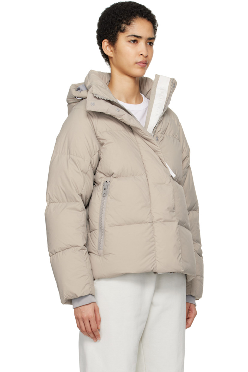 Lightweight down-filled quilted EnduraLuxe CORDURA® nylon taffeta jacket. Water-resistant, wind-resistant, and durable.

· Reflective trim at detachable hood
· Hook strap and bungee-style drawstring at hood
· Funnel neck
· Two-way zip closure with press-stud placket
· Zip pockets
· Concealed bungee-style drawstring at hem
· Raglan sleeves
· Rubberized logo patch at sleeve
· Inset rib knit cuffs
· Patch pockets at interior
· Logo-woven webbing shoulder straps at interior
· Full nylon taffeta lining

Supplier color: Limestone

Fill: 90% goose down, 10% goose feather.