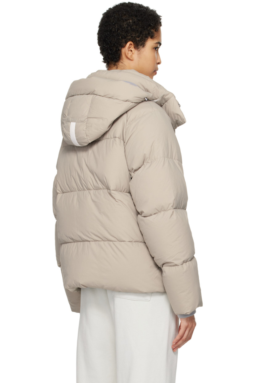 Lightweight down-filled quilted EnduraLuxe CORDURA® nylon taffeta jacket. Water-resistant, wind-resistant, and durable.

· Reflective trim at detachable hood
· Hook strap and bungee-style drawstring at hood
· Funnel neck
· Two-way zip closure with press-stud placket
· Zip pockets
· Concealed bungee-style drawstring at hem
· Raglan sleeves
· Rubberized logo patch at sleeve
· Inset rib knit cuffs
· Patch pockets at interior
· Logo-woven webbing shoulder straps at interior
· Full nylon taffeta lining

Supplier color: Limestone

Fill: 90% goose down, 10% goose feather.