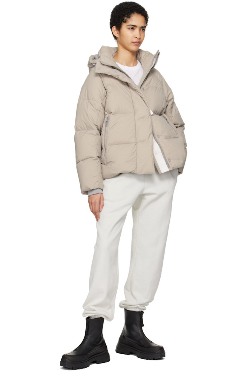 Lightweight down-filled quilted EnduraLuxe CORDURA® nylon taffeta jacket. Water-resistant, wind-resistant, and durable.

· Reflective trim at detachable hood
· Hook strap and bungee-style drawstring at hood
· Funnel neck
· Two-way zip closure with press-stud placket
· Zip pockets
· Concealed bungee-style drawstring at hem
· Raglan sleeves
· Rubberized logo patch at sleeve
· Inset rib knit cuffs
· Patch pockets at interior
· Logo-woven webbing shoulder straps at interior
· Full nylon taffeta lining

Supplier color: Limestone

Fill: 90% goose down, 10% goose feather.