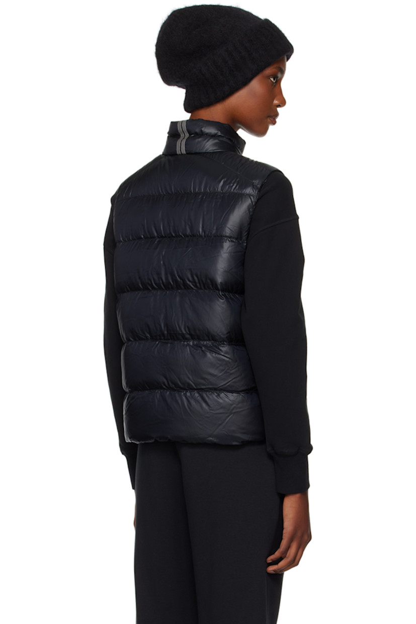 Packable down-filled and quilted recycled nylon ripstop vest. Lightweight, water-repellent, and wind-resistant.

· Stand collar
· Two-way zip closure
· Embroidered logo patch at chest
· Zip pockets
· Bungee-style drawstring at hem
· Patch pocket at interior
· Fully lined

Supplier color: Black

Fill: 90% duck down, 10% duck feather.