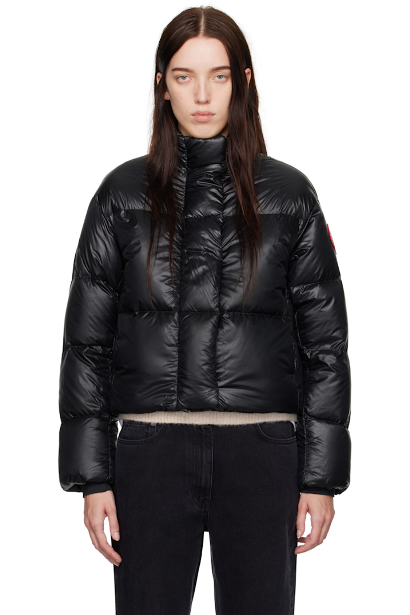 Packable down-filled and quilted recycled nylon ripstop jacket. Lightweight, water-repellent, and wind-resistant.

· Stand collar
· Two-way zip closure and button placket
· Seam pockets
· Bungee-style drawstring at cropped hem
· Dropped shoulders
· Embroidered logo patch at sleeve
· Rib-knit cuffs
· Detachable shoulder straps at interior
· Welt pocket at interior
· Mesh patch pockets at interior

Supplier color: Black

Fill: 90% duck down, 10% down feather.