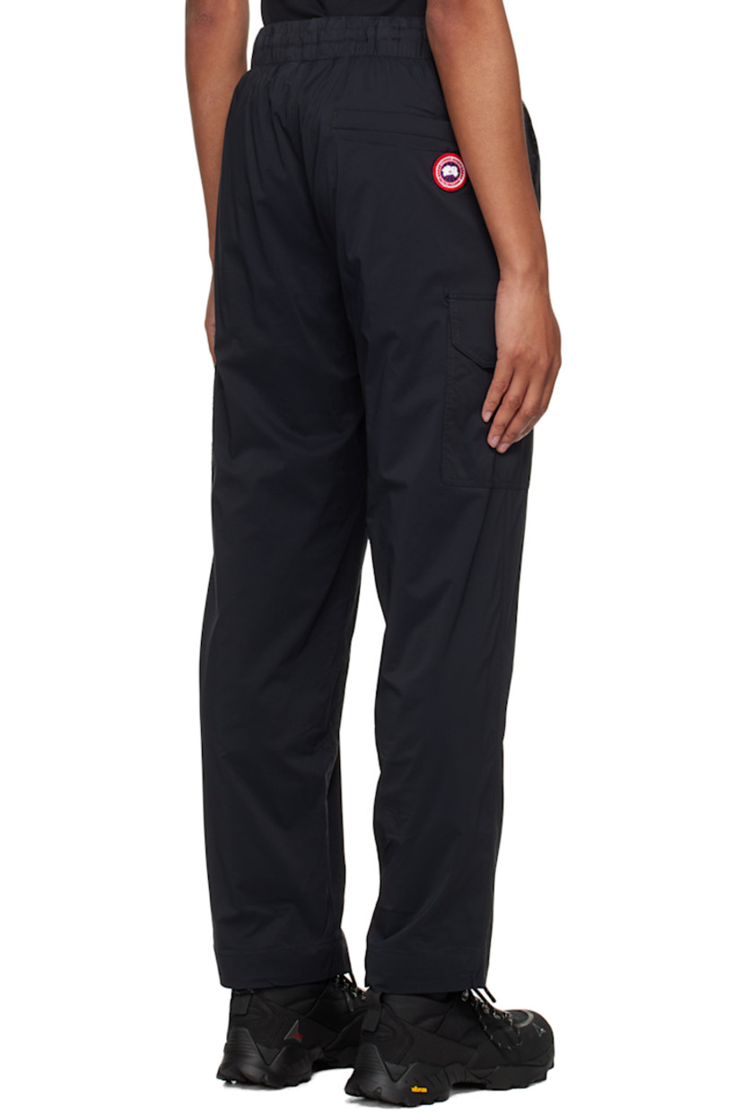 Nylon ripstop trousers. 

· Drawstring at elasticized waistband
· Three-pocket styling
· Mock-fly
· Cargo pocket at outseams
· Embroidered logo patch at back
· Full mesh lining

Supplier color: Black
