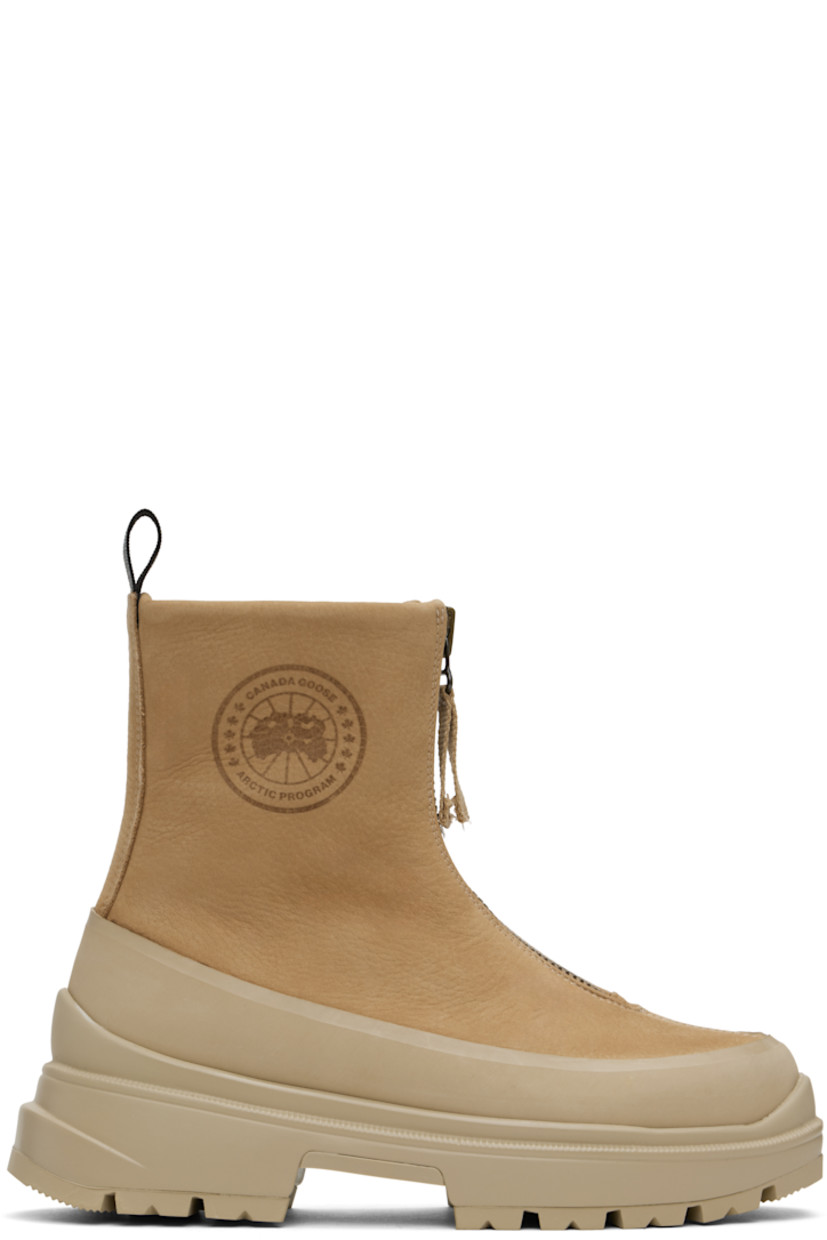 Ankle-high grained leather boots in tan.

· Rubber trim throughout
· Zip closure
· Logo embossed at outer side
· Reflective pull-loop at heel collar
· Logo patch at shearling footbed
· Buffed leather lining
· Serrated edge at welt
· Treaded rubber sole

Supplier color: Tan