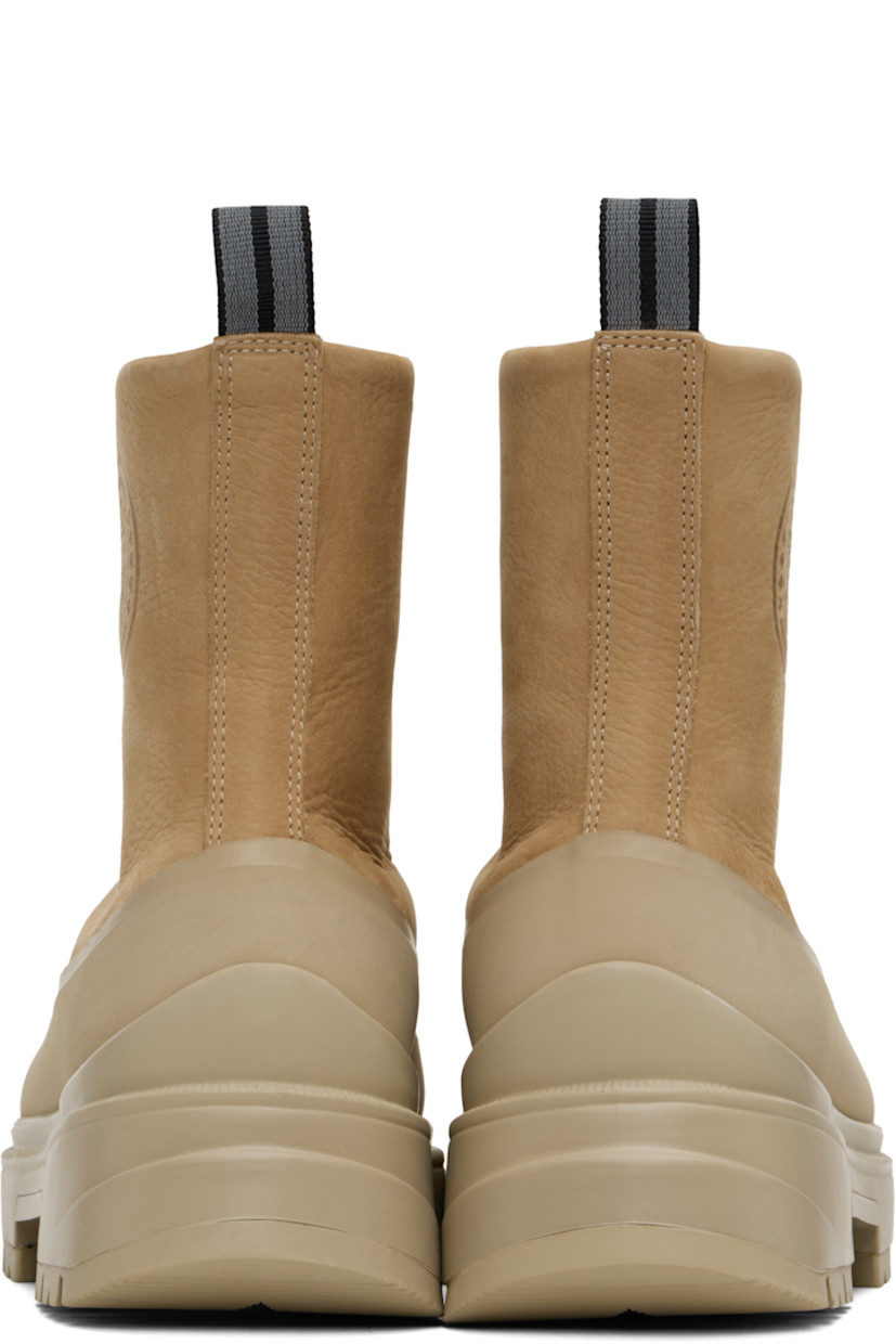 Ankle-high grained leather boots in tan.

· Rubber trim throughout
· Zip closure
· Logo embossed at outer side
· Reflective pull-loop at heel collar
· Logo patch at shearling footbed
· Buffed leather lining
· Serrated edge at welt
· Treaded rubber sole

Supplier color: Tan