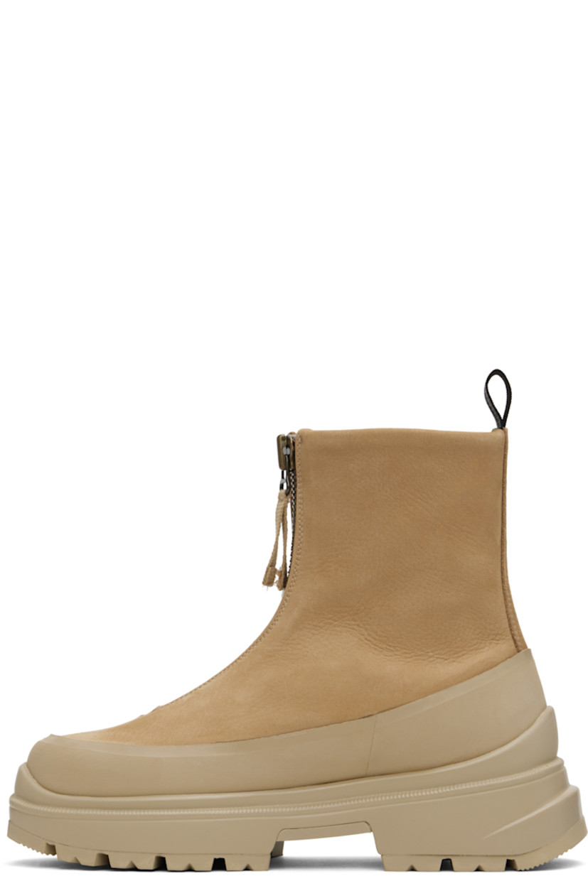 Ankle-high grained leather boots in tan.

· Rubber trim throughout
· Zip closure
· Logo embossed at outer side
· Reflective pull-loop at heel collar
· Logo patch at shearling footbed
· Buffed leather lining
· Serrated edge at welt
· Treaded rubber sole

Supplier color: Tan