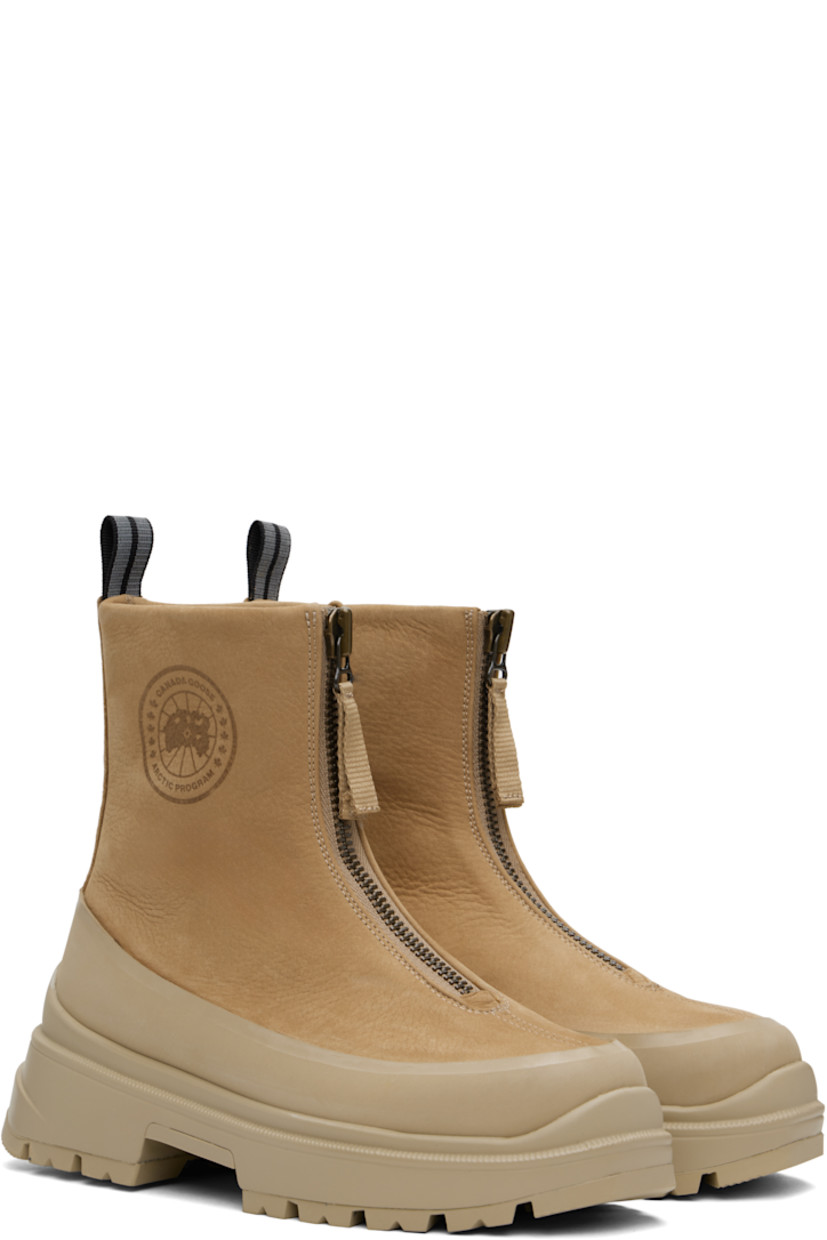 Ankle-high grained leather boots in tan.

· Rubber trim throughout
· Zip closure
· Logo embossed at outer side
· Reflective pull-loop at heel collar
· Logo patch at shearling footbed
· Buffed leather lining
· Serrated edge at welt
· Treaded rubber sole

Supplier color: Tan