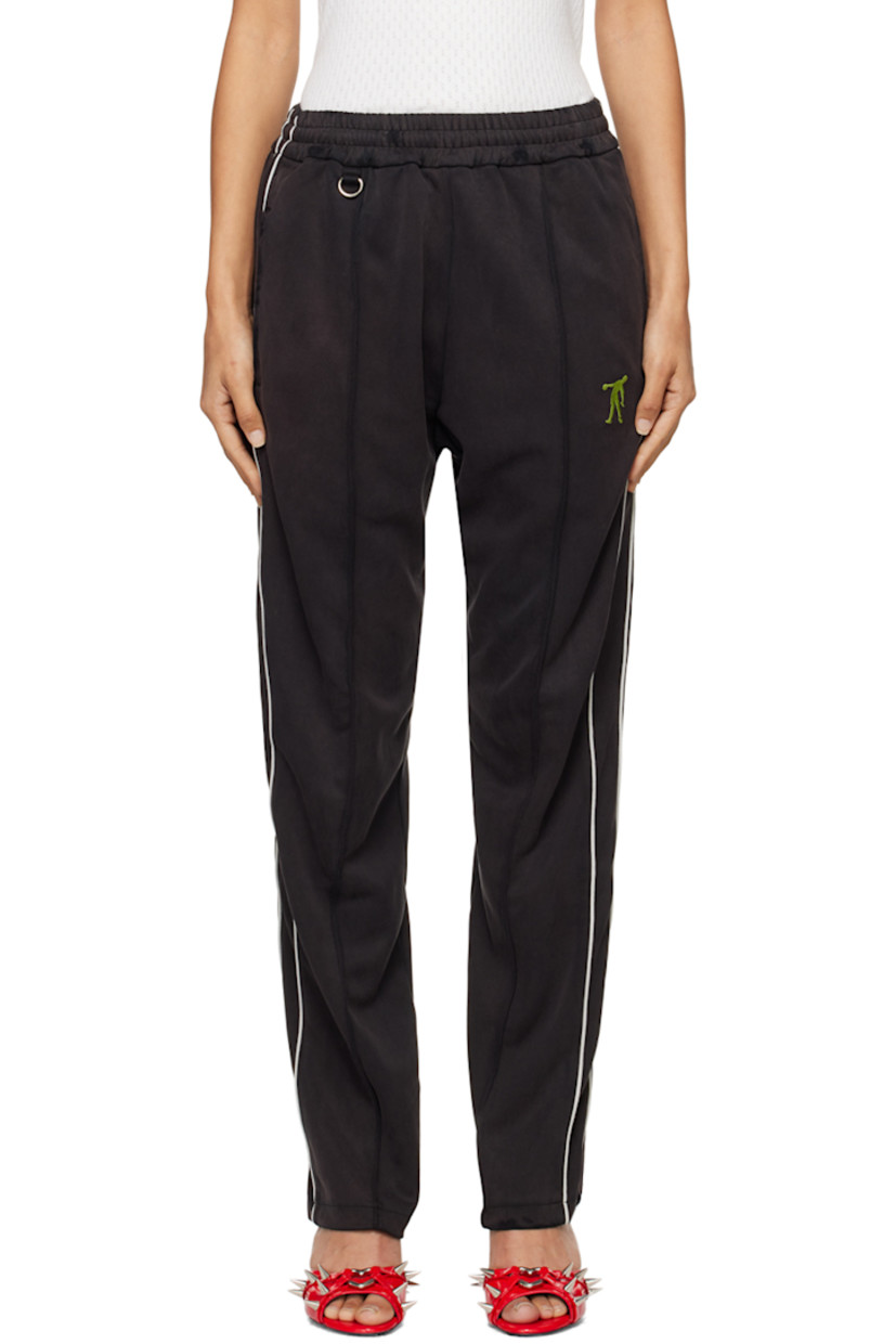 Polyester- and cupro-blend piqué track pants.

· Concealed drawstring at elasticized waistband
· Three-pocket styling
· D-ring at front
· Graphic embroidered at front
· Piping at outseams

Supplier color: Black