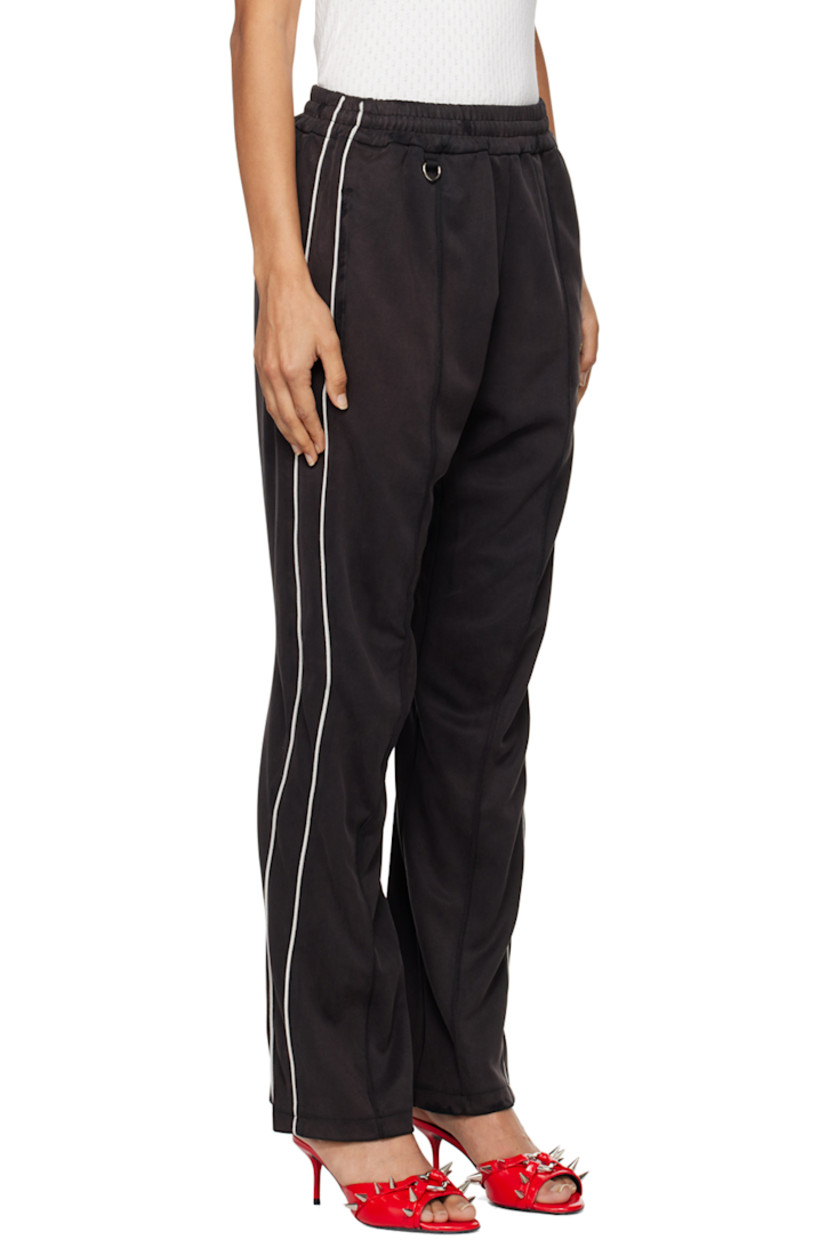 Polyester- and cupro-blend piqué track pants.

· Concealed drawstring at elasticized waistband
· Three-pocket styling
· D-ring at front
· Graphic embroidered at front
· Piping at outseams

Supplier color: Black