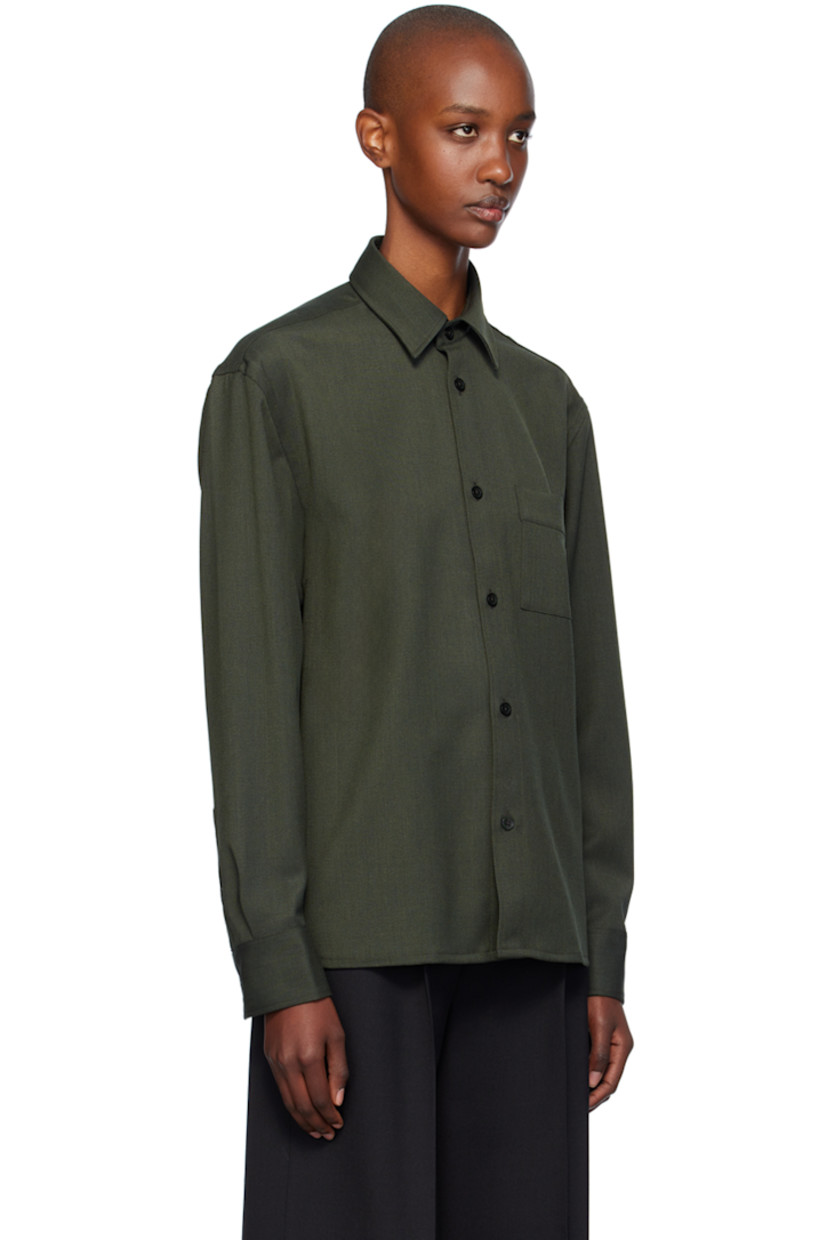 Stretch polyester- and merino wool-blend cavalry twill shirt.

· Boxy-fit
· Spread collar
· Button closure
· Patch pocket
· Adjustable single-button barrel cuffs
· Locker loop at back yoke

Supplier color: Green melange