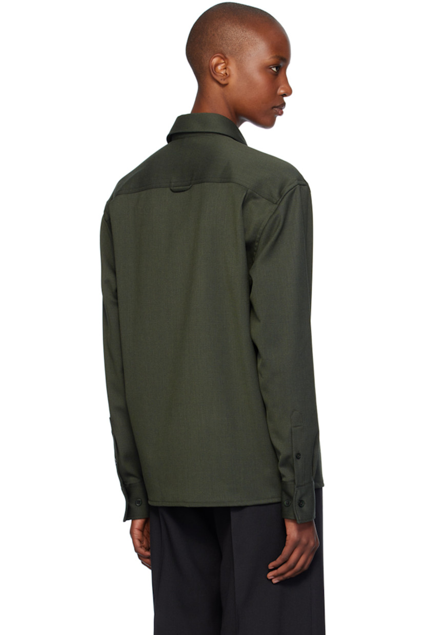 Stretch polyester- and merino wool-blend cavalry twill shirt.

· Boxy-fit
· Spread collar
· Button closure
· Patch pocket
· Adjustable single-button barrel cuffs
· Locker loop at back yoke

Supplier color: Green melange