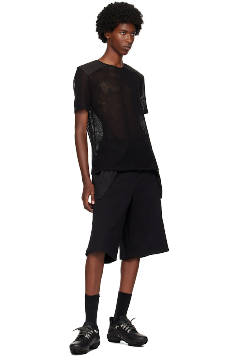 Nylon mesh and canvas T-shirt. 

· Paneled construction 
· Crewneck
· Logo embroidered at back collar
· Logo flag at back yoke

Supplier color: Black