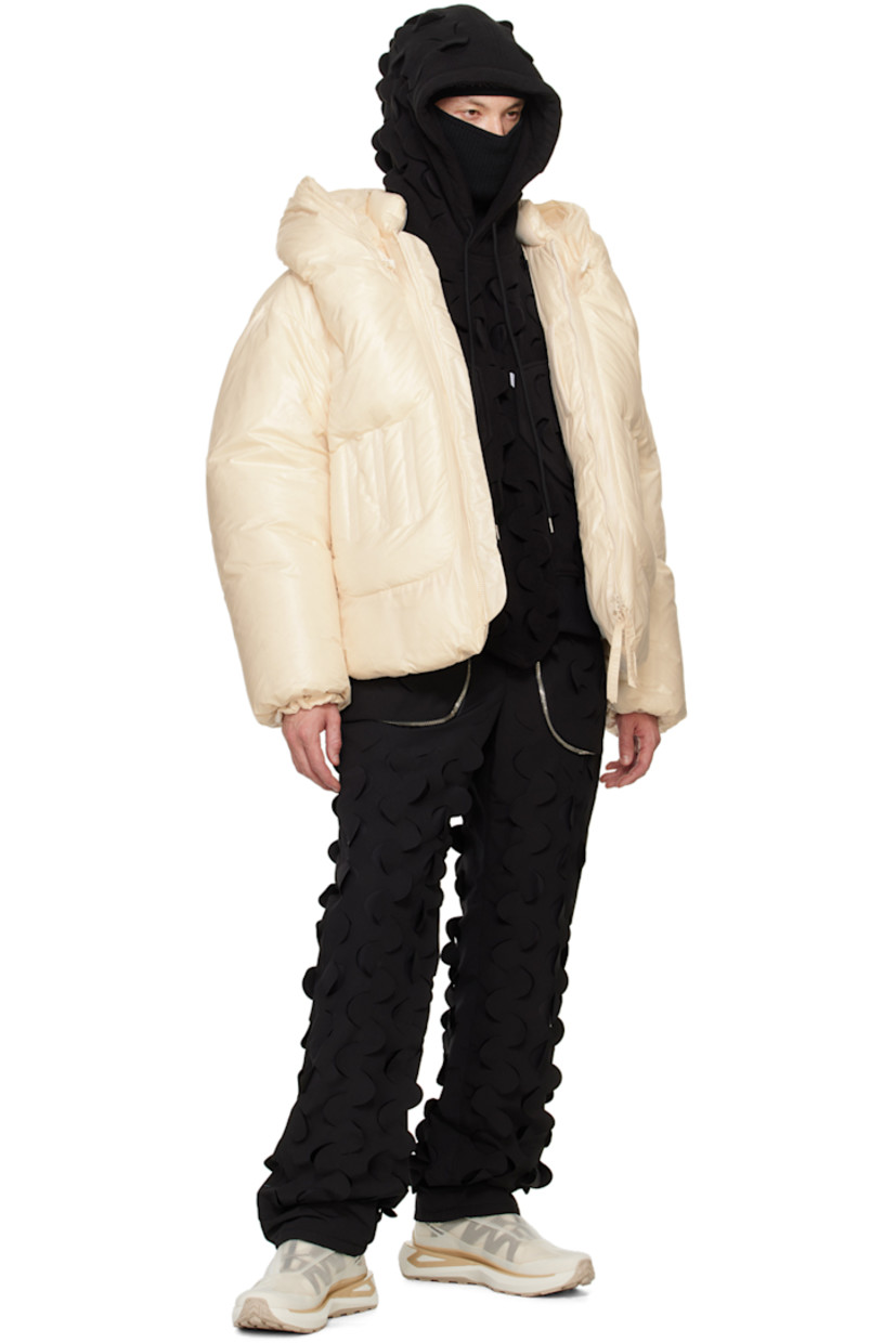 Down-filled polyester taffeta jacket. 

· Bungee-style drawstring at hood
· Stand collar
· Two-way zip closure
· Embroidered detailing at front 
· Zip pockets
· Concealed bungee-style drawstring at hem 
· Elasticized cuffs
· Welt pocket and patch pockets at interior
· Full fleece and taffeta lining

Supplier color: Cream

Fill: 100% goose down.