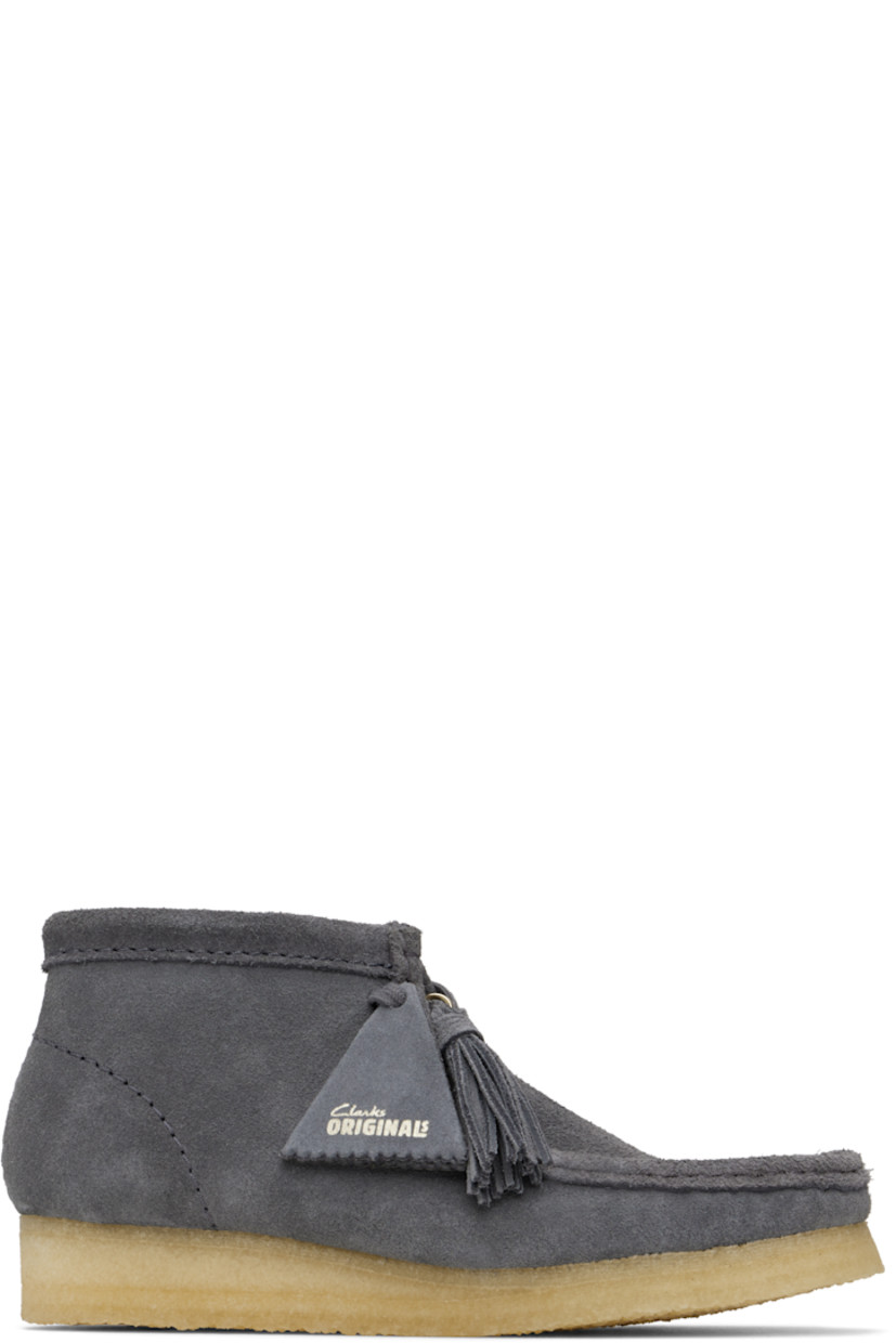 Ankle-high suede boots in gray.

· Square moc toe
· Logo tags and tassel at lace-up closure
· Bellows tongue
· Suede and grained sheepskin lining
· EVA rubber midsole
· FSC-certified crepe rubber sole
· Includes additional laces in gray

Supplier color: Grey/Blue suede