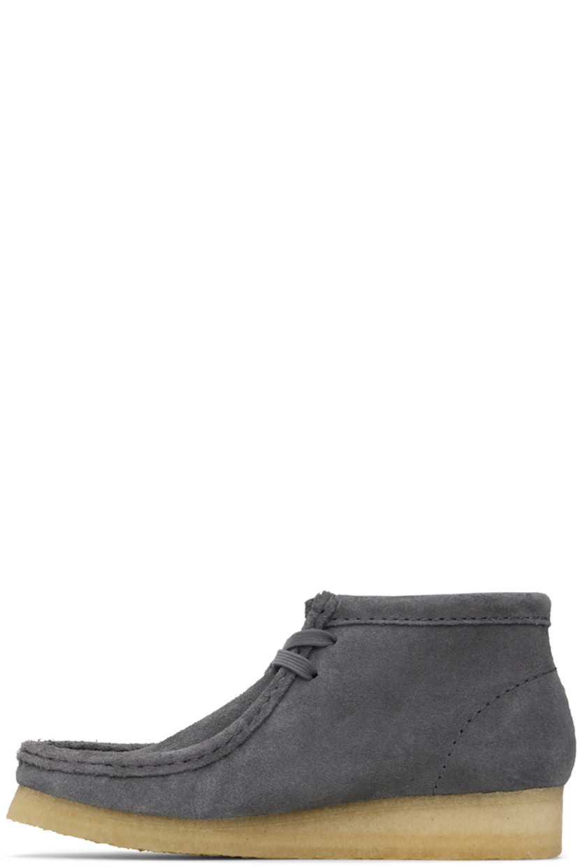 Ankle-high suede boots in gray.

· Square moc toe
· Logo tags and tassel at lace-up closure
· Bellows tongue
· Suede and grained sheepskin lining
· EVA rubber midsole
· FSC-certified crepe rubber sole
· Includes additional laces in gray

Supplier color: Grey/Blue suede