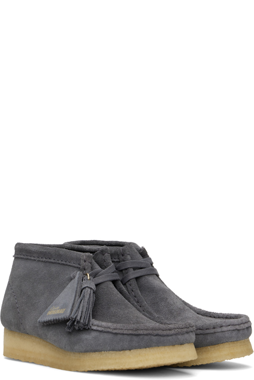 Ankle-high suede boots in gray.

· Square moc toe
· Logo tags and tassel at lace-up closure
· Bellows tongue
· Suede and grained sheepskin lining
· EVA rubber midsole
· FSC-certified crepe rubber sole
· Includes additional laces in gray

Supplier color: Grey/Blue suede