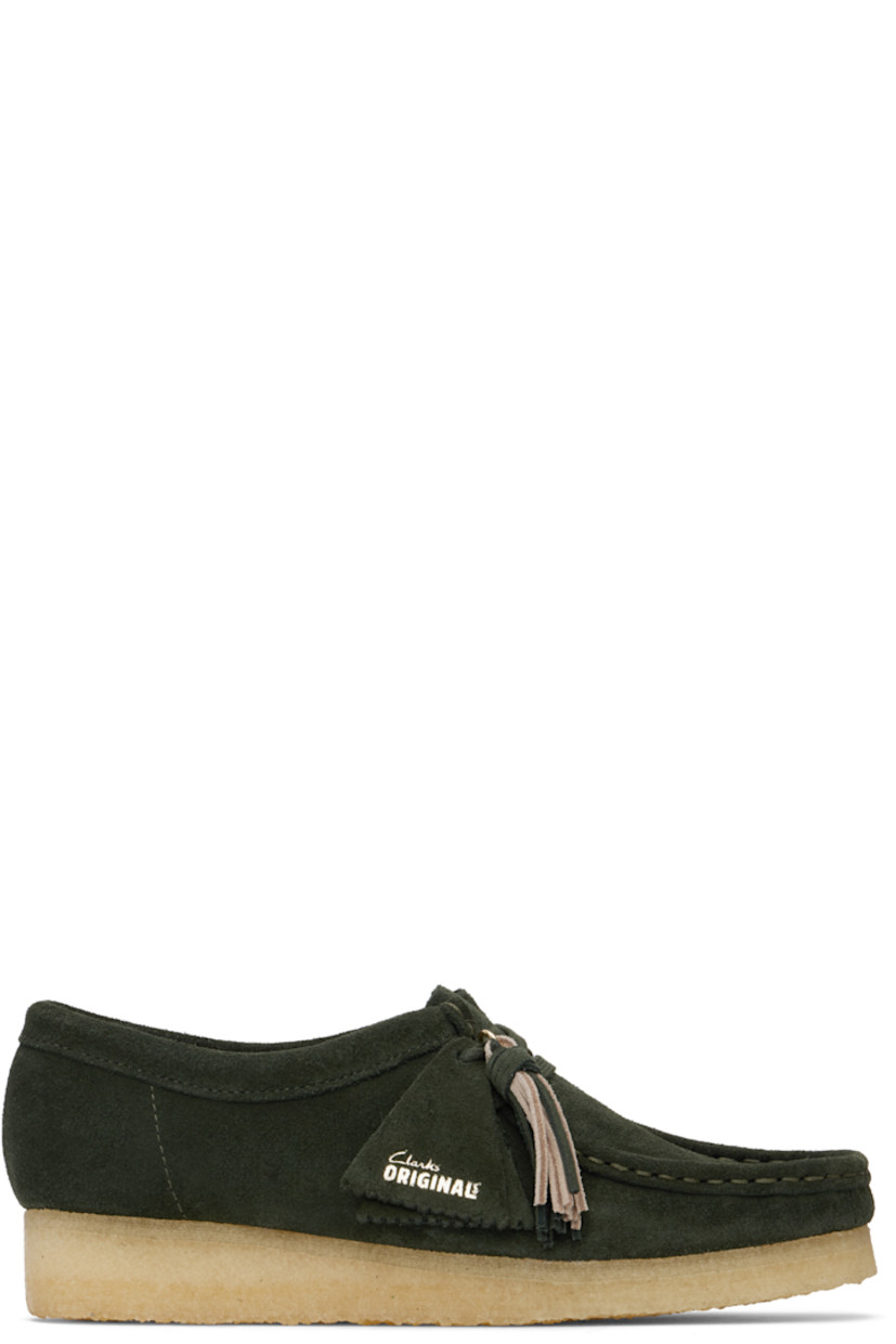 Suede derbys in green.

· Square moc toe
· Logo tags and tassel at lace-up closure
· Bellows tongue
· Suede and grained leather lining
· EVA rubber midsole
· FSC-certified crepe rubber sole
· Includes additional laces in khaki

Supplier color: Forest green suede
