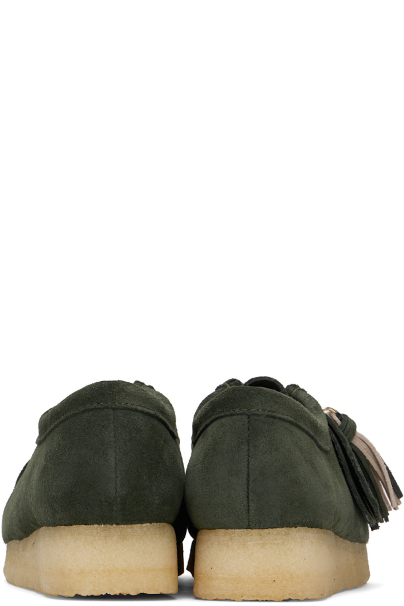 Suede derbys in green.

· Square moc toe
· Logo tags and tassel at lace-up closure
· Bellows tongue
· Suede and grained leather lining
· EVA rubber midsole
· FSC-certified crepe rubber sole
· Includes additional laces in khaki

Supplier color: Forest green suede