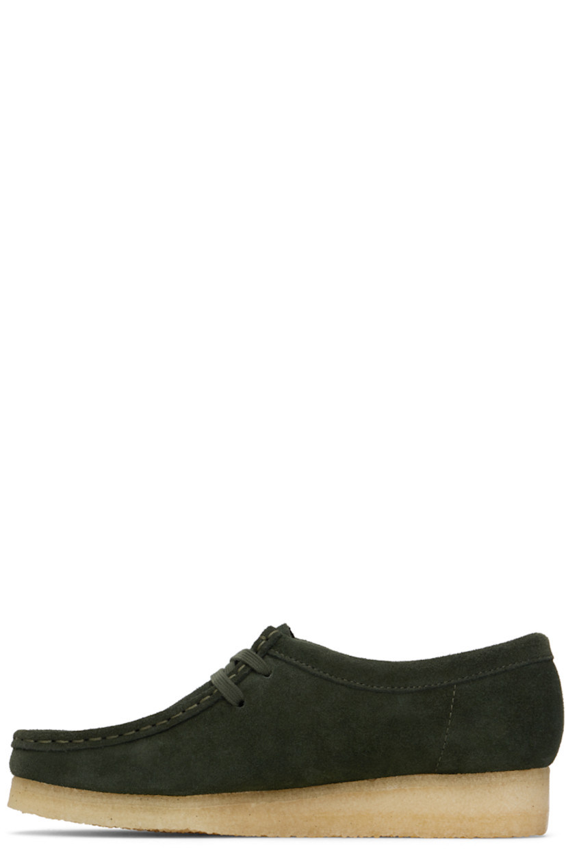 Suede derbys in green.

· Square moc toe
· Logo tags and tassel at lace-up closure
· Bellows tongue
· Suede and grained leather lining
· EVA rubber midsole
· FSC-certified crepe rubber sole
· Includes additional laces in khaki

Supplier color: Forest green suede