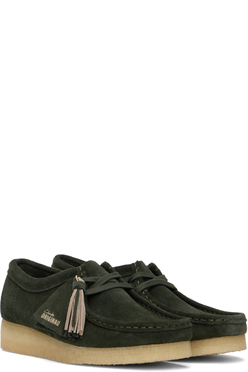 Suede derbys in green.

· Square moc toe
· Logo tags and tassel at lace-up closure
· Bellows tongue
· Suede and grained leather lining
· EVA rubber midsole
· FSC-certified crepe rubber sole
· Includes additional laces in khaki

Supplier color: Forest green suede