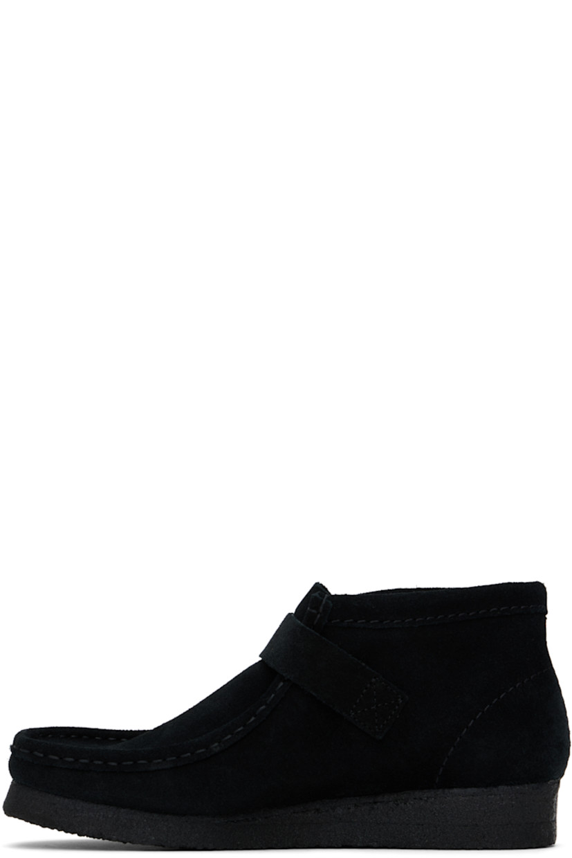 Ankle-high suede boots in black.

· Hand-stitched detailing at square moc toe
· Pin-buckle strap at vamp
· Bellows tongue
· Suede lining
· EVA rubber midsole
· FSC-certified crepe rubber sole

Supplier color: Black suede