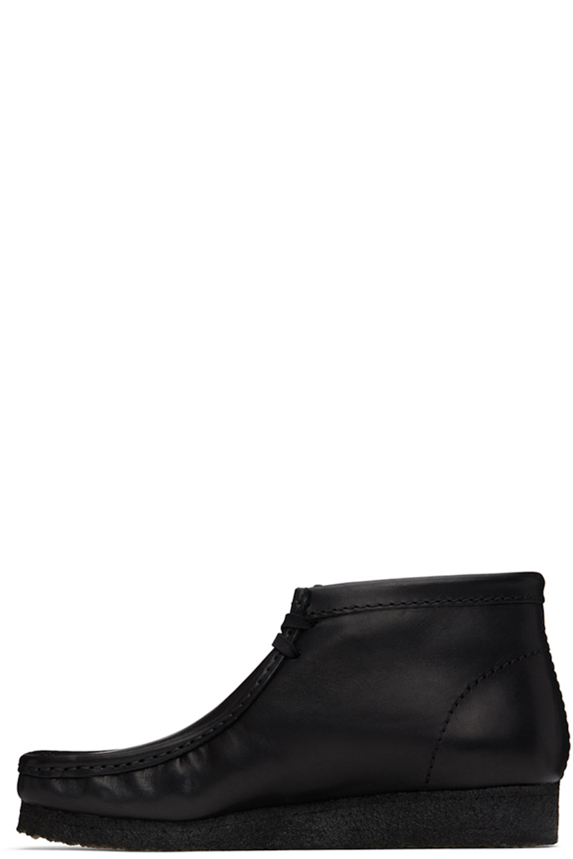 Ankle-high buffed leather boots in black.

· Square moc toe
· Logo tags at lace-up closure
· Suede lining
· EVA rubber midsole
· FSC-certified crepe rubber sole

Supplier color: Black leather