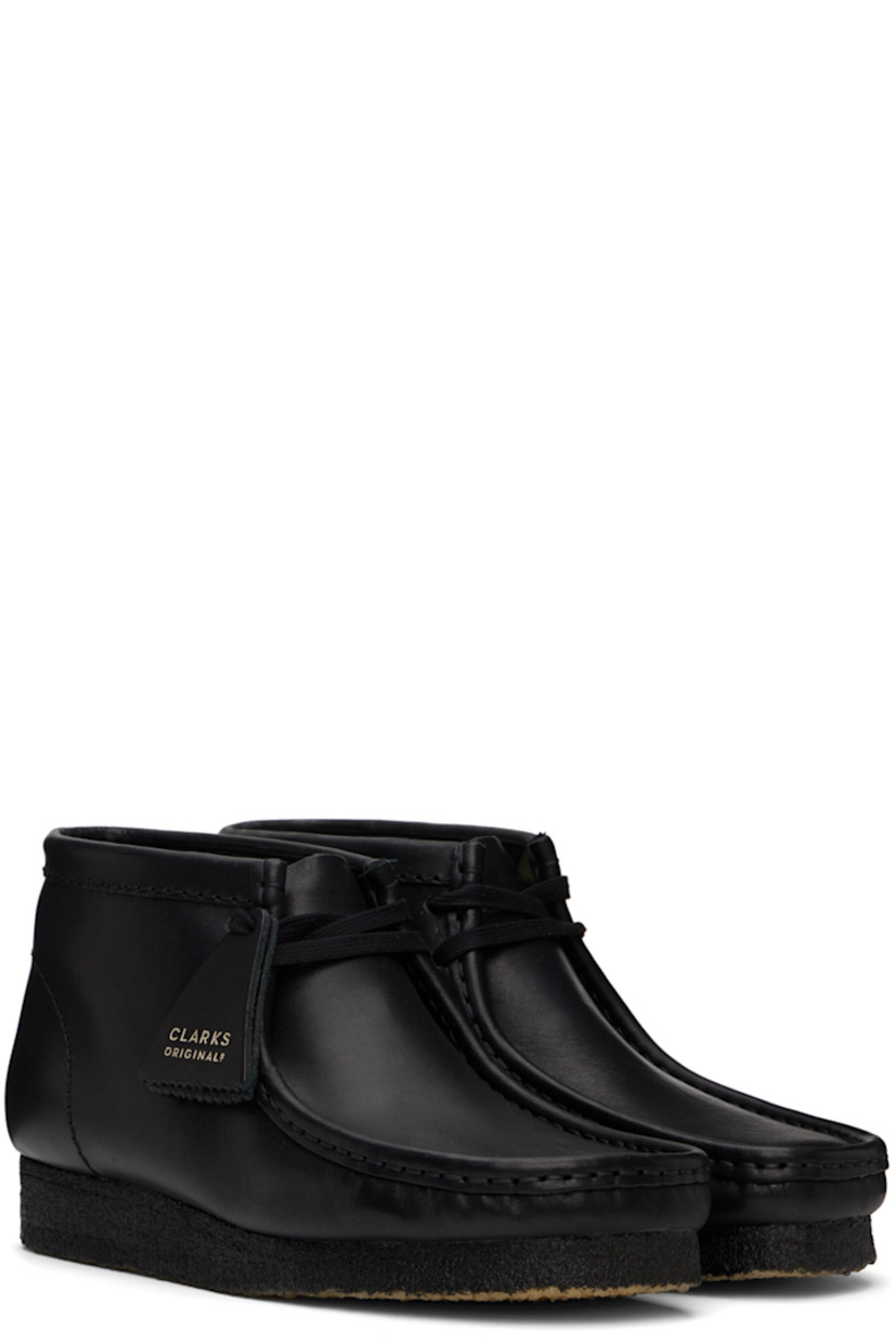 Ankle-high buffed leather boots in black.

· Square moc toe
· Logo tags at lace-up closure
· Suede lining
· EVA rubber midsole
· FSC-certified crepe rubber sole

Supplier color: Black leather