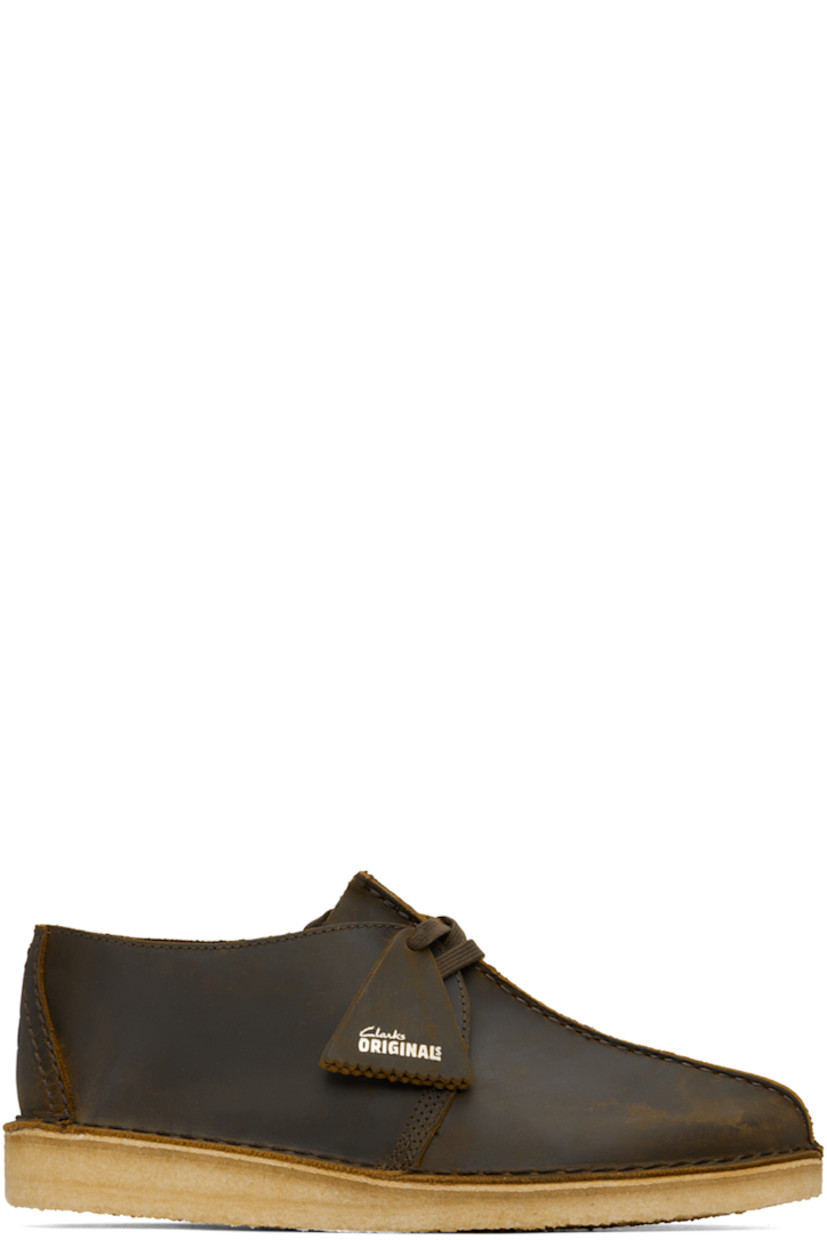 Waxed leather derbys in brown.

· Pinched seam at vamp
· Logo tags at lace-up closure
· Graphic embossed at heel counter
· Suede lining
· EVA rubber midsole
· FSC-certified crepe rubber sole
· Includes additional laces in orange

Supplier color: Beeswax