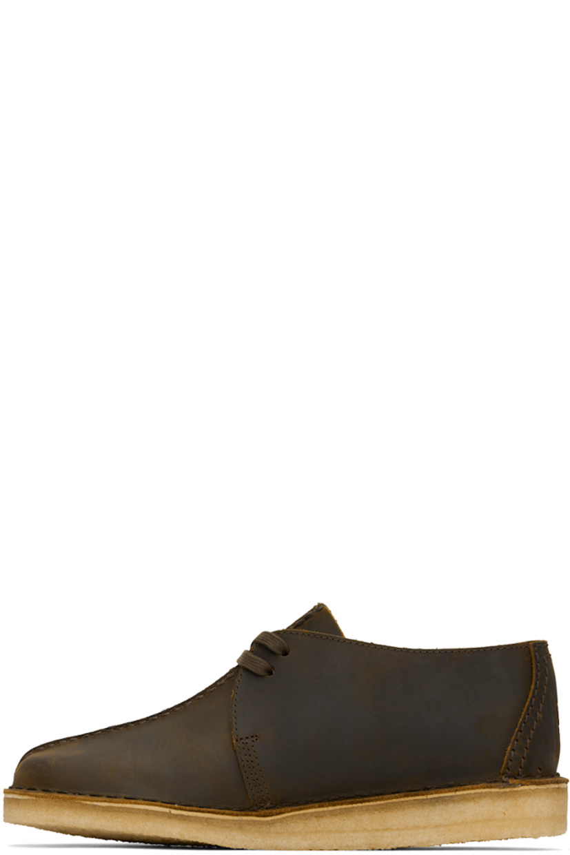 Waxed leather derbys in brown.

· Pinched seam at vamp
· Logo tags at lace-up closure
· Graphic embossed at heel counter
· Suede lining
· EVA rubber midsole
· FSC-certified crepe rubber sole
· Includes additional laces in orange

Supplier color: Beeswax