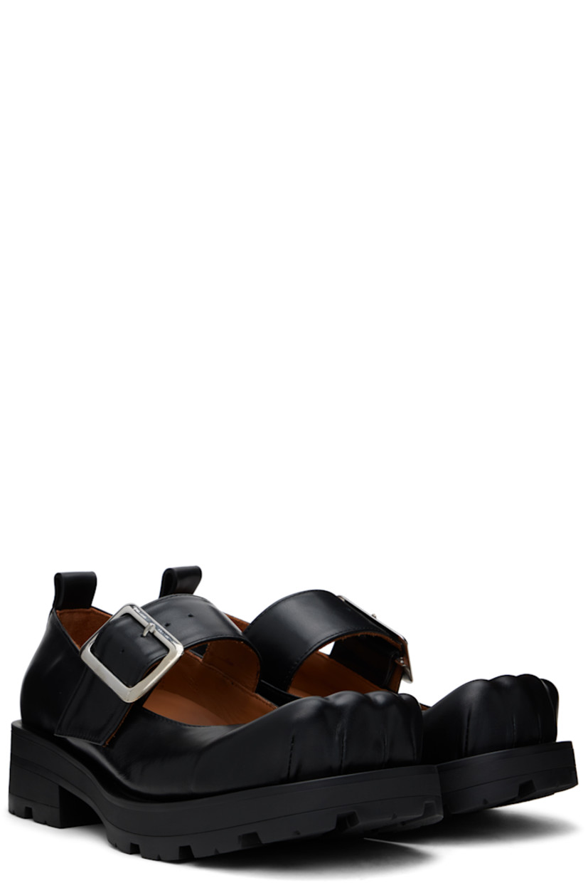 Buffed leather Mary Jane-style loafers in black.

· Sculptural square toe
· Pin-buckle strap at vamp
· Pull-loop at heel
· Cushioned insole
· Buffed leather lining
· Rubber block heel
· Treaded rubber sole
· Heel: H1.75"

Supplier color: Black