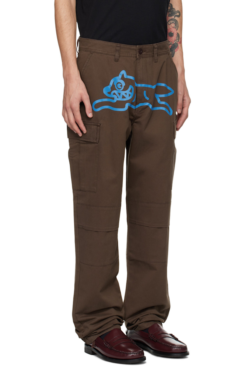 Cotton twill cargo pants.

· Belt loops
· Four-pocket styling
· Zip-fly
· Graphic printed at front
· Pleat at knees
· Concealed drawstring at cuffs
· Cargo pocket at outseams
· Logo patch at back pocket

Supplier color: Brown