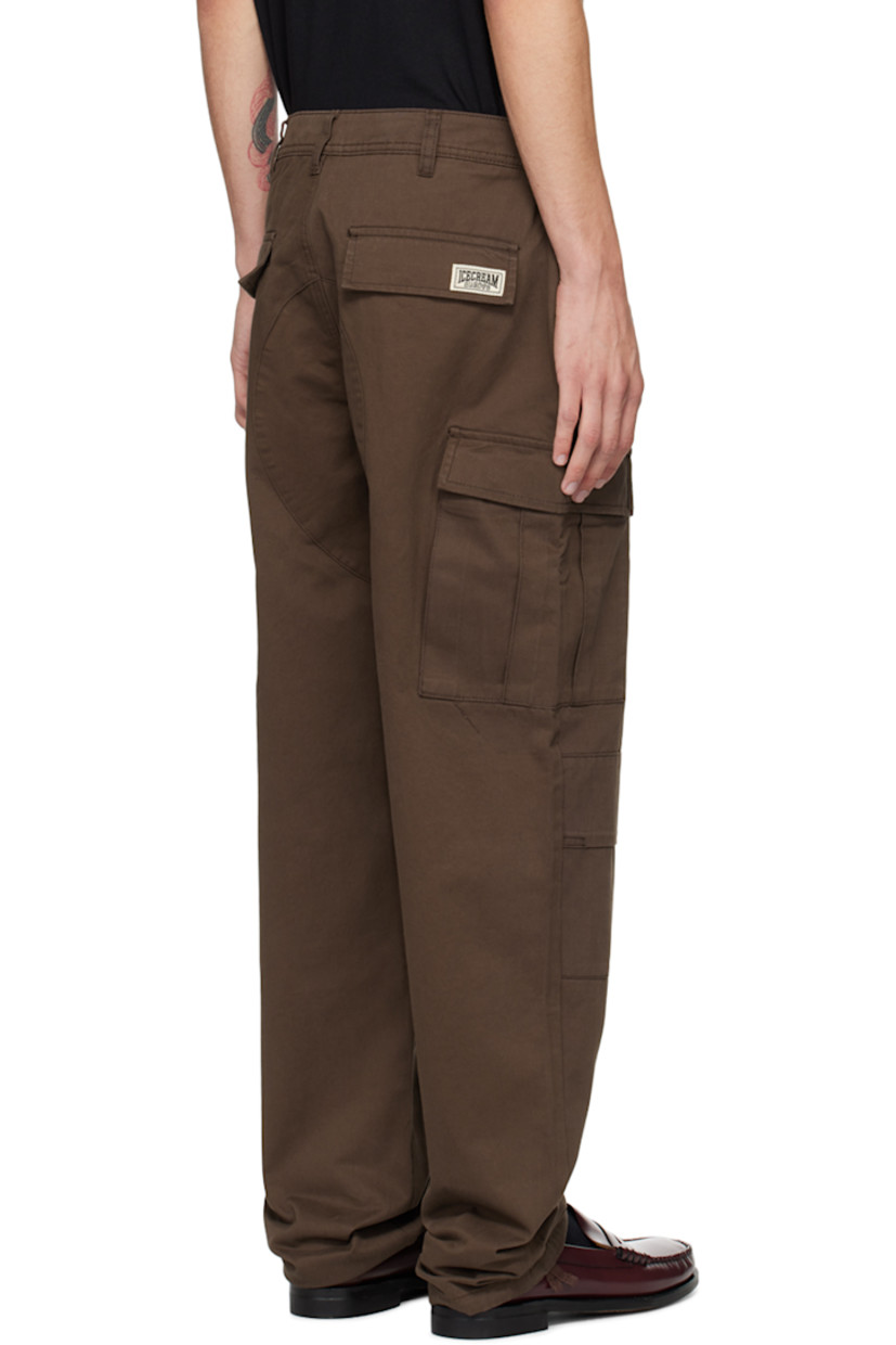 Cotton twill cargo pants.

· Belt loops
· Four-pocket styling
· Zip-fly
· Graphic printed at front
· Pleat at knees
· Concealed drawstring at cuffs
· Cargo pocket at outseams
· Logo patch at back pocket

Supplier color: Brown