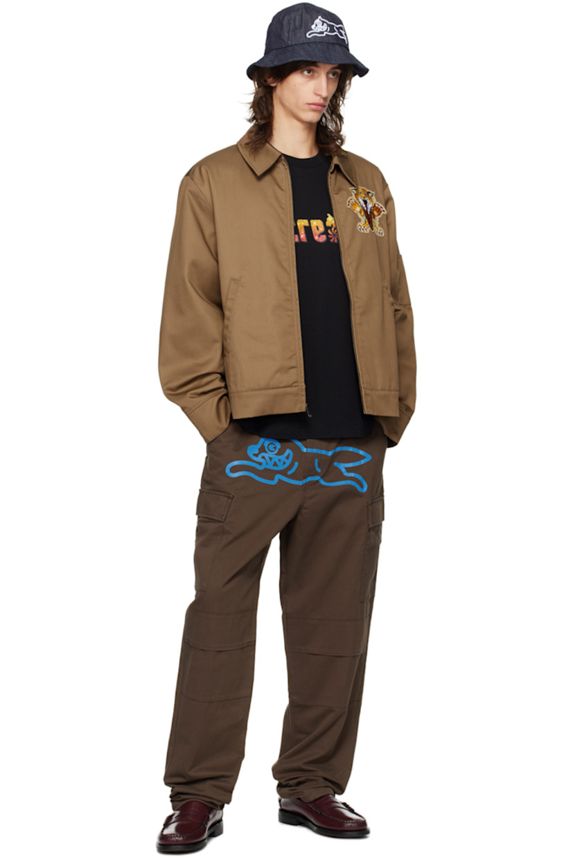 Cotton twill cargo pants.

· Belt loops
· Four-pocket styling
· Zip-fly
· Graphic printed at front
· Pleat at knees
· Concealed drawstring at cuffs
· Cargo pocket at outseams
· Logo patch at back pocket

Supplier color: Brown