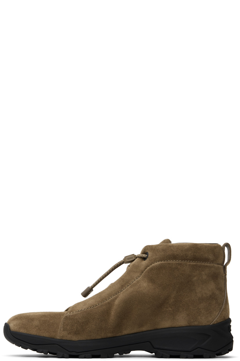 High-top suede sneakers in beige.

· Elasticized criss-crossing straps at vamp
· Bungee-style drawstring closure
· Logo bonded at padded tongue
· Padded collar
· Pull-loop at heel tab
· Logo embossed at heel
· Buffed leather lining
· Treaded Vibram® Arctic Grip rubber sole

Supplier color: Beige