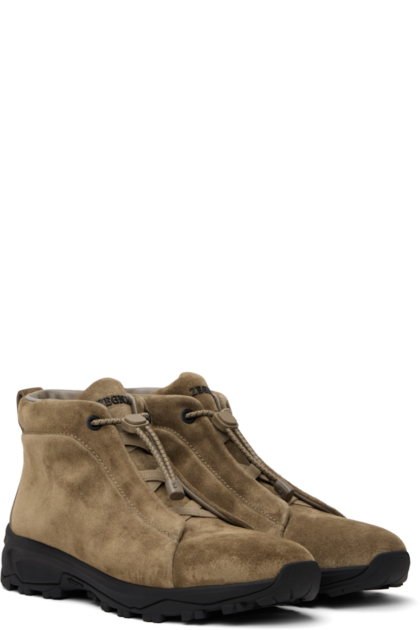High-top suede sneakers in beige.

· Elasticized criss-crossing straps at vamp
· Bungee-style drawstring closure
· Logo bonded at padded tongue
· Padded collar
· Pull-loop at heel tab
· Logo embossed at heel
· Buffed leather lining
· Treaded Vibram® Arctic Grip rubber sole

Supplier color: Beige