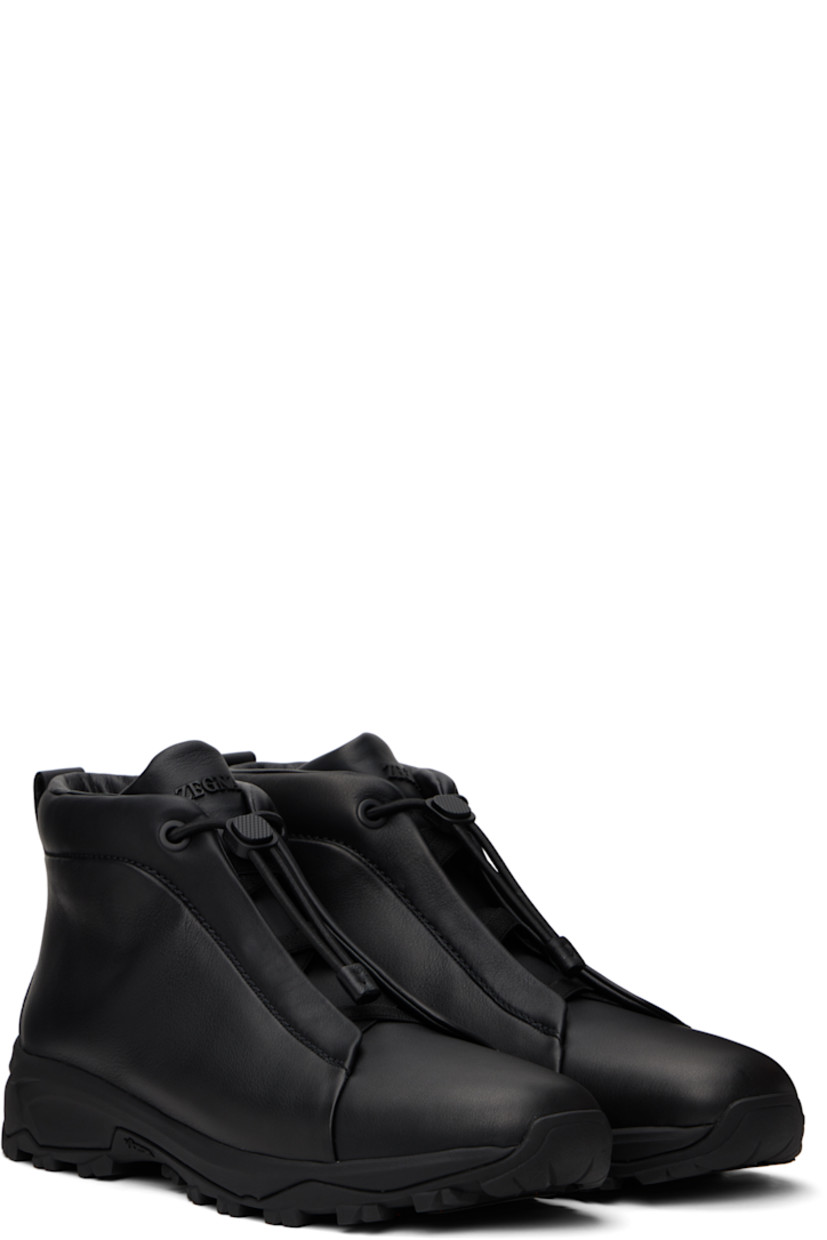 High-top grained calfskin sneakers in black.

· Elasticized criss-crossing straps at vamp
· Bungee-style drawstring closure
· Logo bonded at padded tongue
· Padded collar
· Pull-loop at heel tab
· Logo embossed at heel
· Buffed leather lining
· Treaded Vibram® Arctic Grip rubber sole

Supplier color: Black