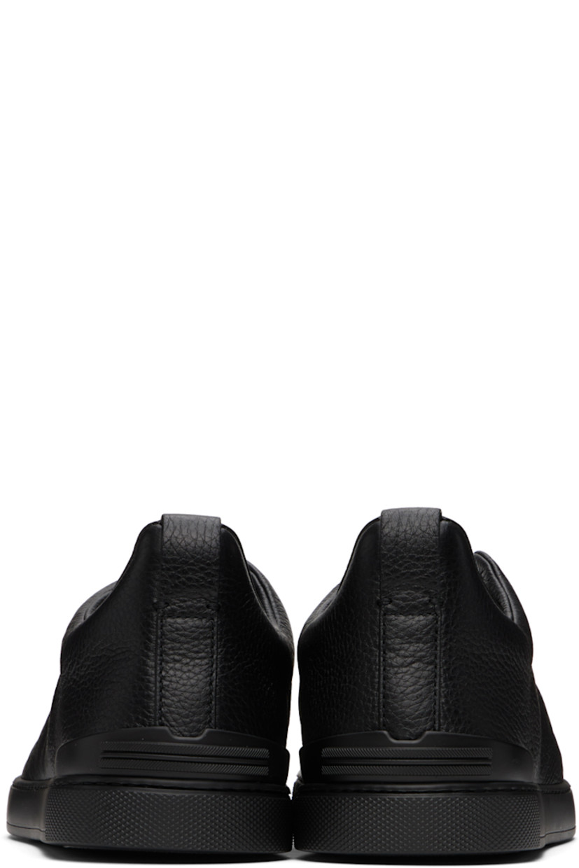 Low-top grained deerskin sneakers in black.

· Elasticized criss-crossing straps at vamp
· Logo embossed at padded tongue
· Padded collar
· Pull-loop at heel tab
· Rubberized logo patch at heel counter
· Removable cushioned Sanitized® insole
· Buffed leather lining
· Treaded rubber sole

Supplier color: Black