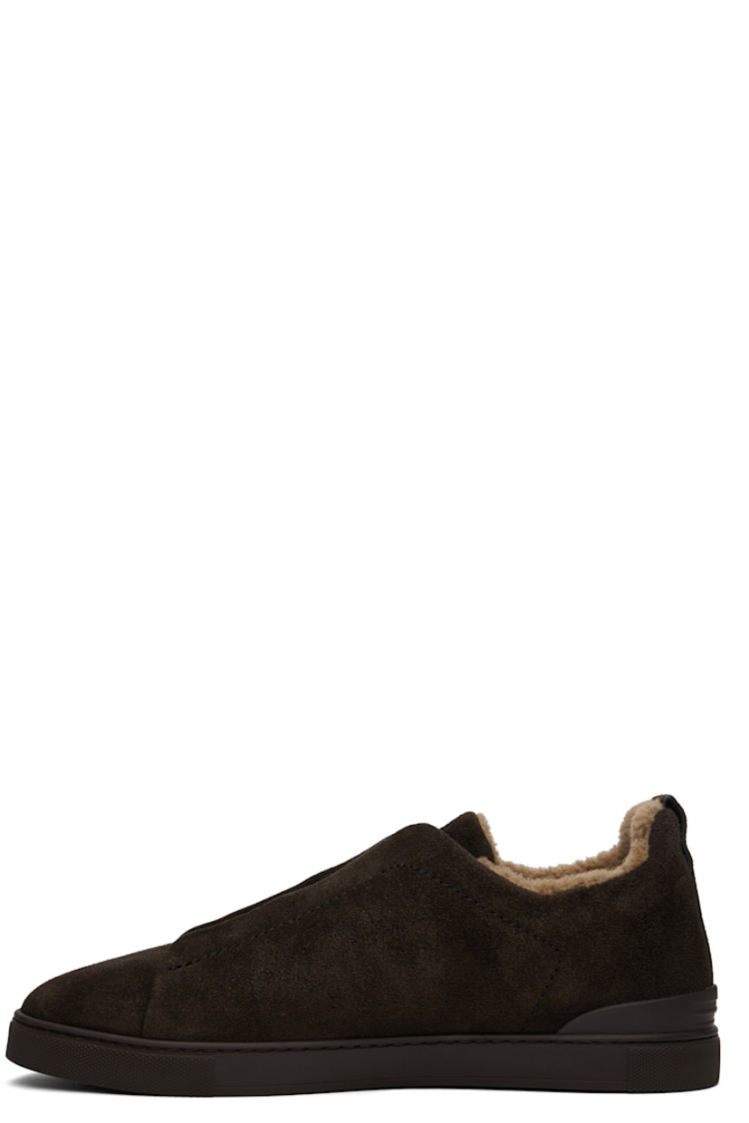 Low-top suede sneakers in brown.

· Elasticized criss-crossing straps at vamp
· Concealed elasticized gussets 
· Logo embossed at padded tongue
· Padded collar
· Pull-loop at heel tab
· Sanitized® footbed
· Wool fleece and suede lining
· Treaded rubber sole

Supplier color: Brown