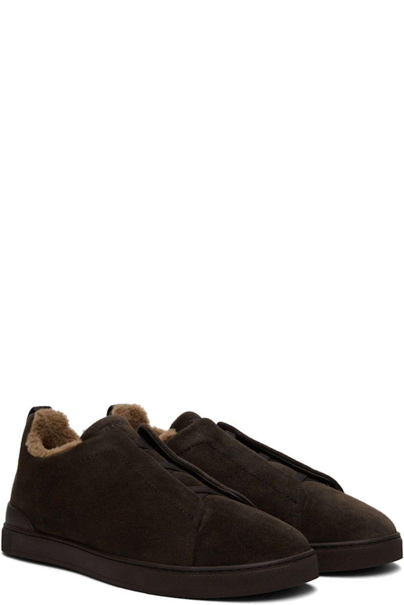 Low-top suede sneakers in brown.

· Elasticized criss-crossing straps at vamp
· Concealed elasticized gussets 
· Logo embossed at padded tongue
· Padded collar
· Pull-loop at heel tab
· Sanitized® footbed
· Wool fleece and suede lining
· Treaded rubber sole

Supplier color: Brown