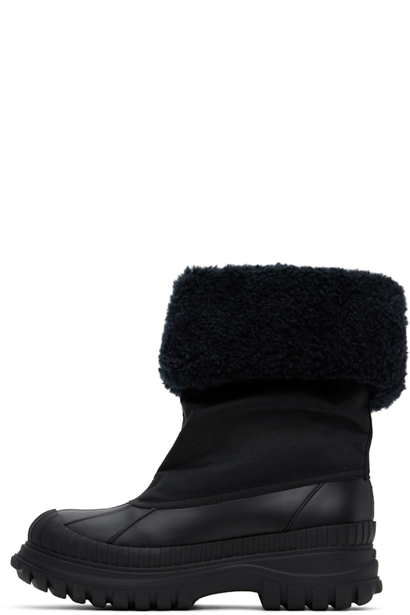 Ankle-high canvas and rubber boots in black.

· Rolled collar
· Extended rubber welt
· Faux-shearling lining
· Logo embossed at heel 
· Lugged rubber sole
· Heel: H2"

Supplier color: Black
