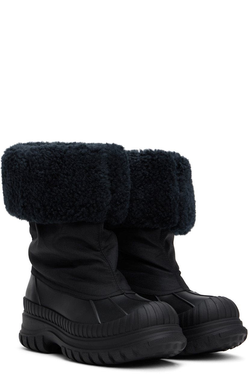 Ankle-high canvas and rubber boots in black.

· Rolled collar
· Extended rubber welt
· Faux-shearling lining
· Logo embossed at heel 
· Lugged rubber sole
· Heel: H2"

Supplier color: Black